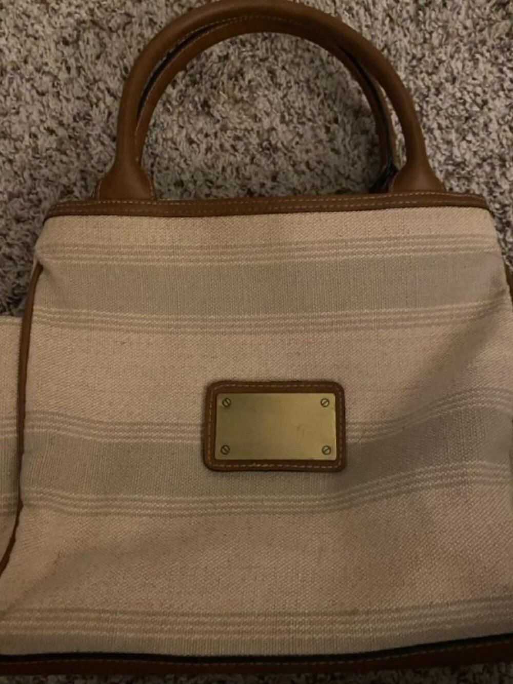 cream and tan striped handbag with gold accents